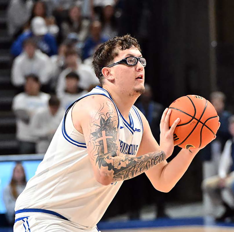 A basketball player holds the ball during a game.