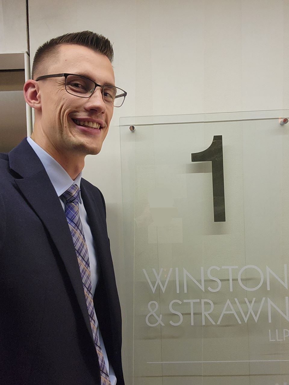 Law student Charlie Kruljac poses outside the firm Winston & Strawn in Paris, France Charlie Kruljac poses at the entrance of a law firm